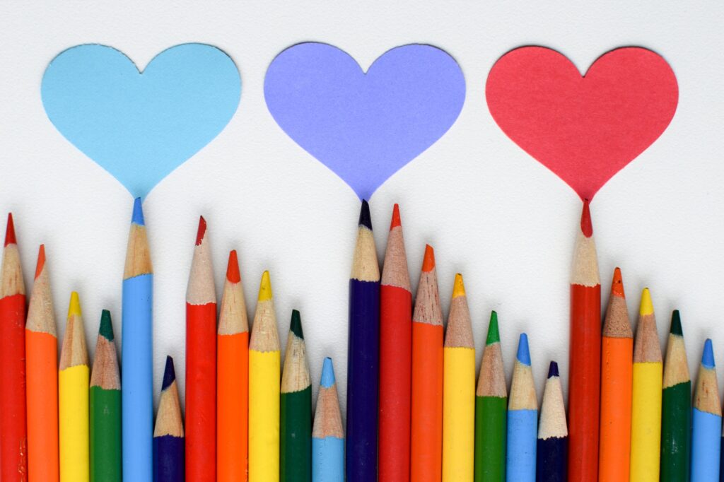 A row of colored pencils and hearts