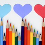 A row of colored pencils and hearts
