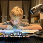 Boy drawing with colors pencils