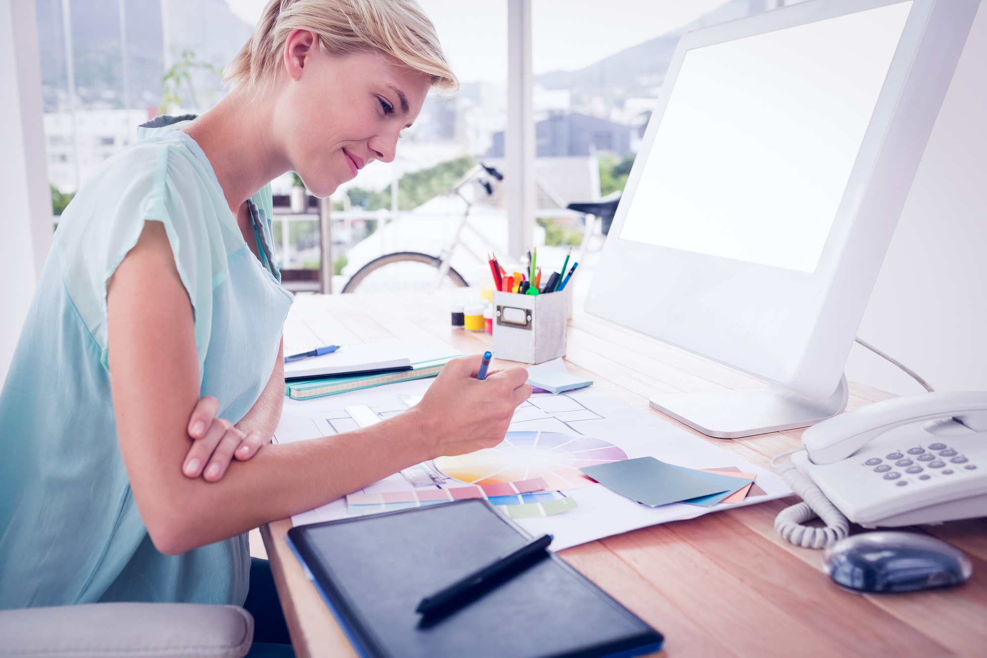 Creative businesswoman drawing plans using colour watch in the office