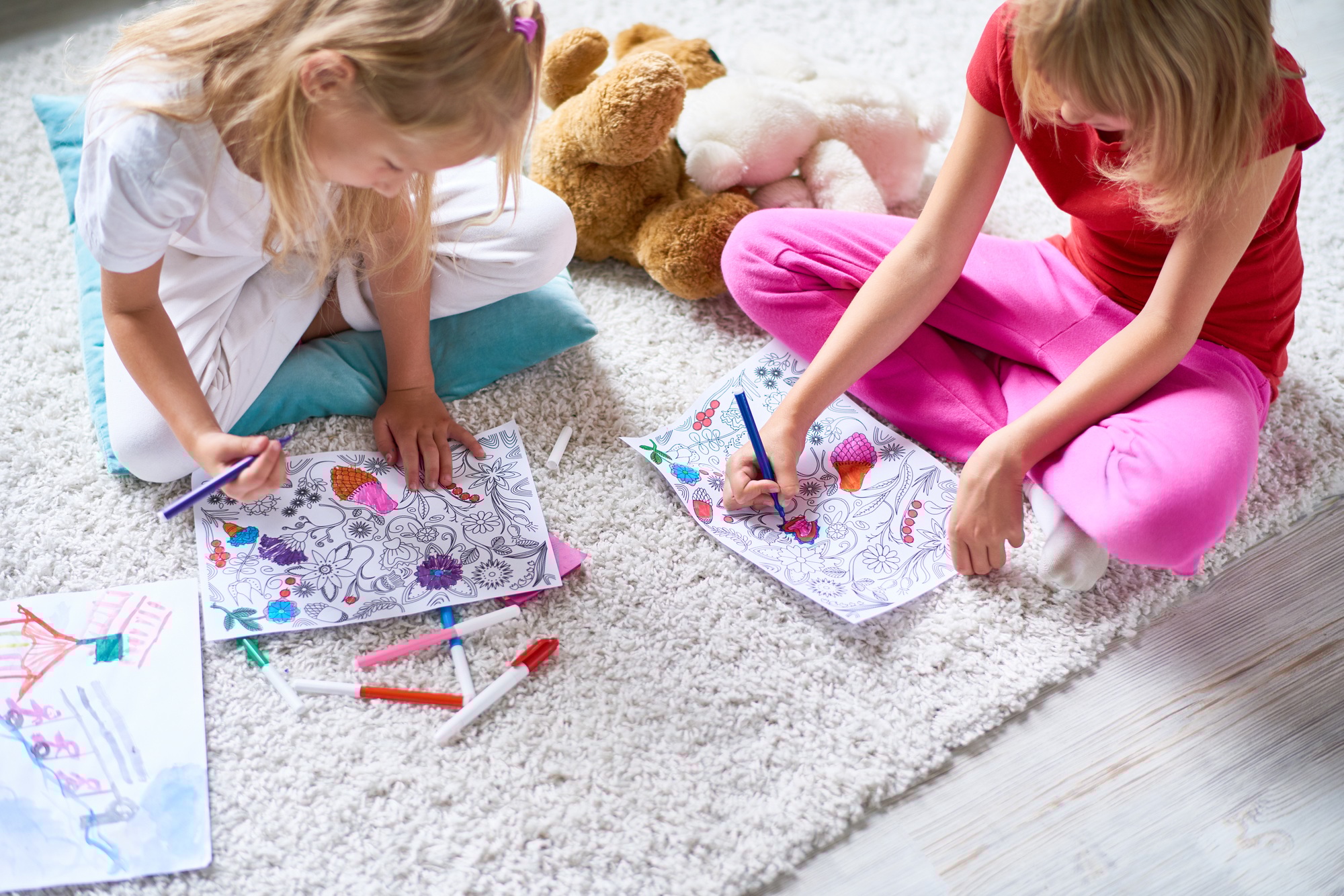 Girls Drawing in Coloring Books on Floor