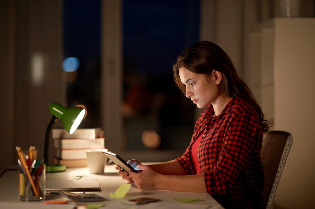 student girl or woman with tablet pc at night home