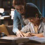 Tutor helping a student with his homework