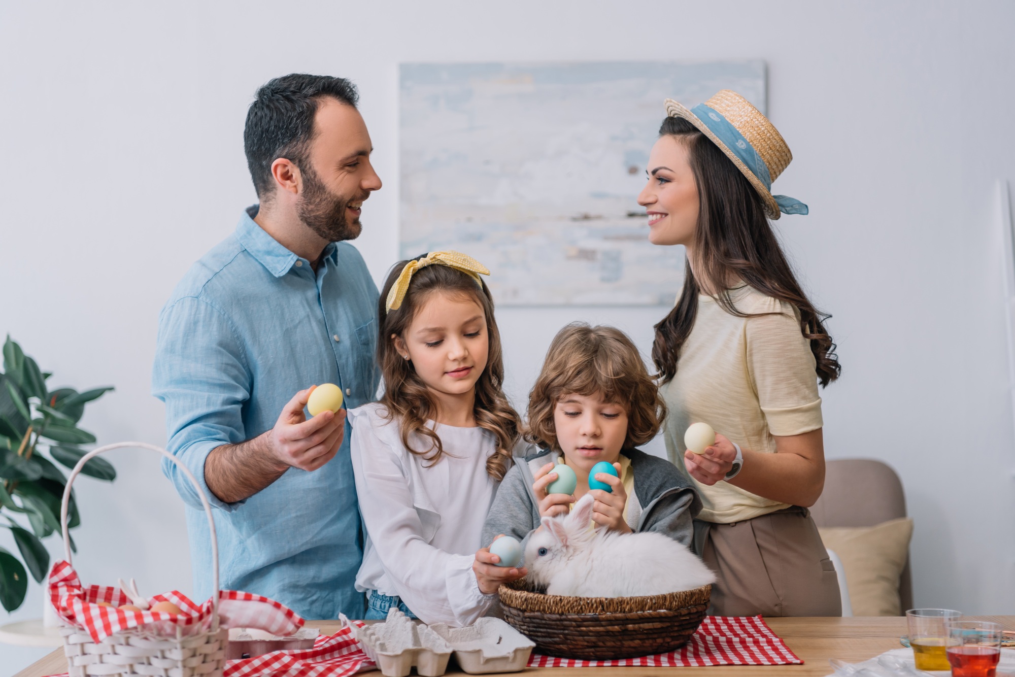 young family with colorful easter eggs preparing for easter